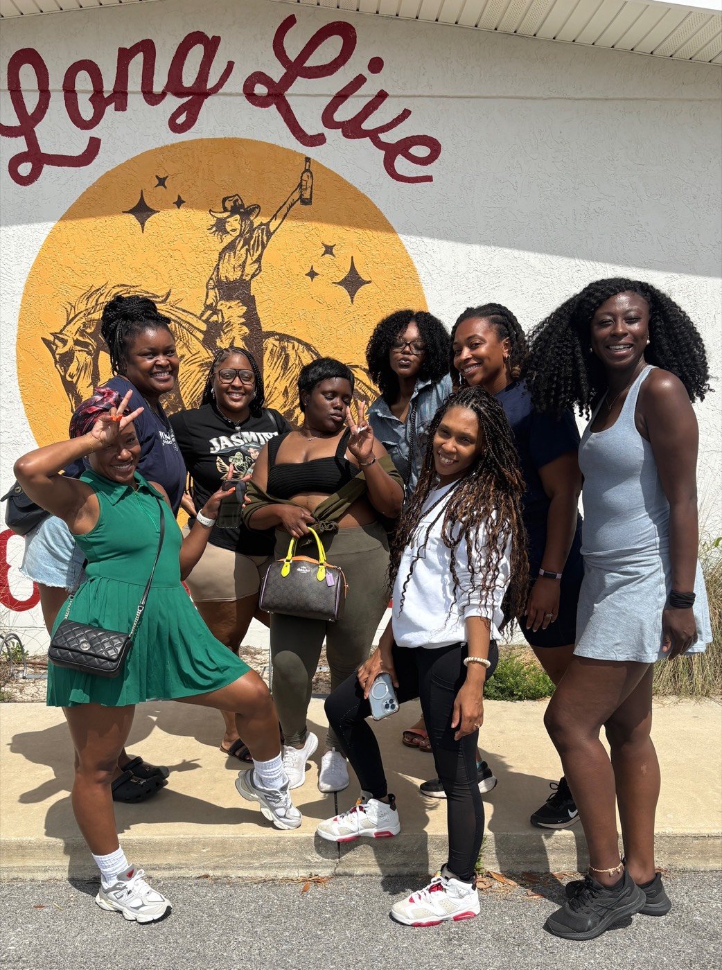 The 2025 group in front of a mural on 30A